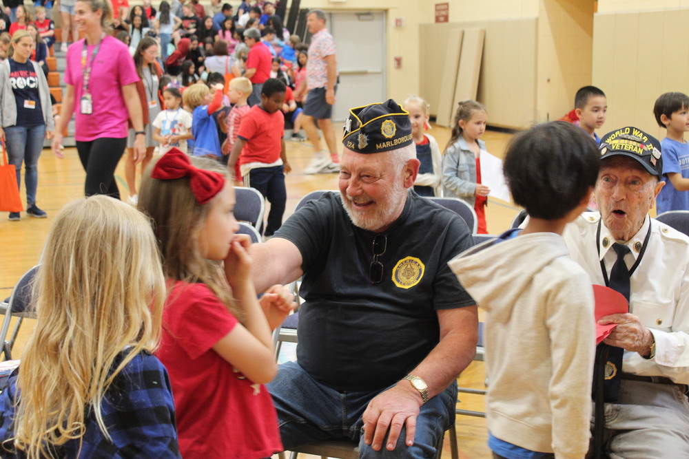 Students greet a veteran
