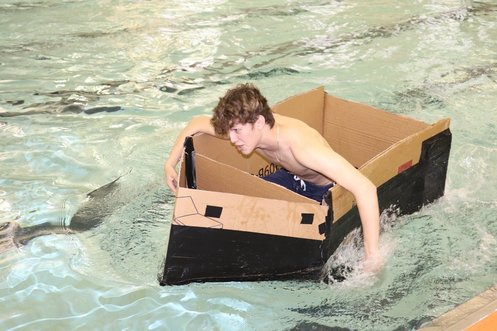 Student in a cardboard boat