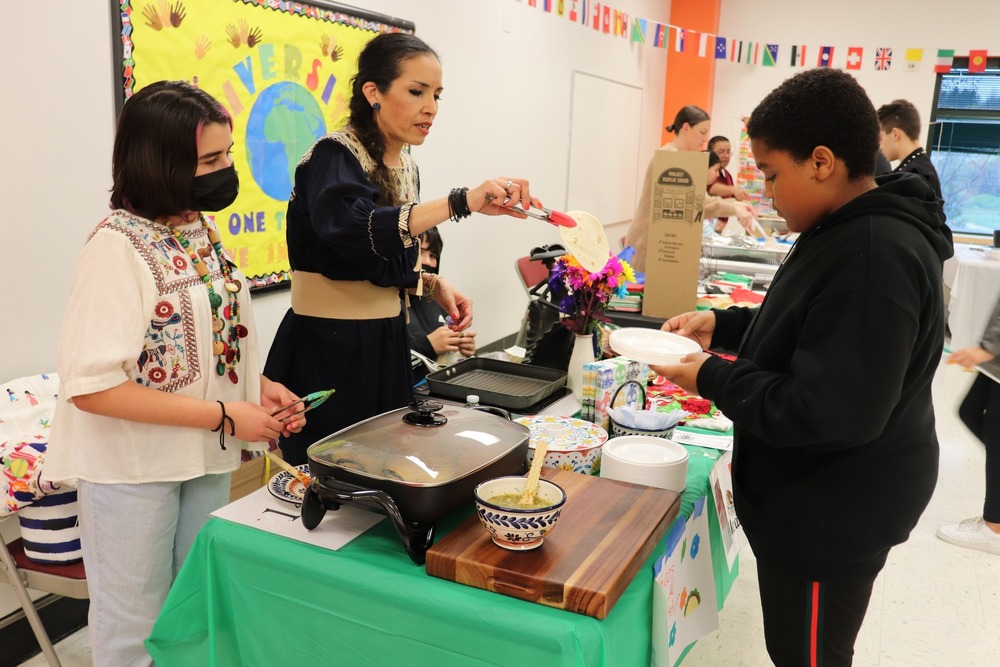 A student being served food.
