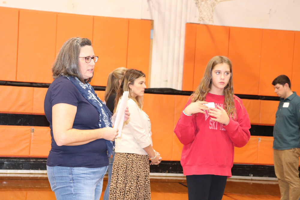 A trainer works with students