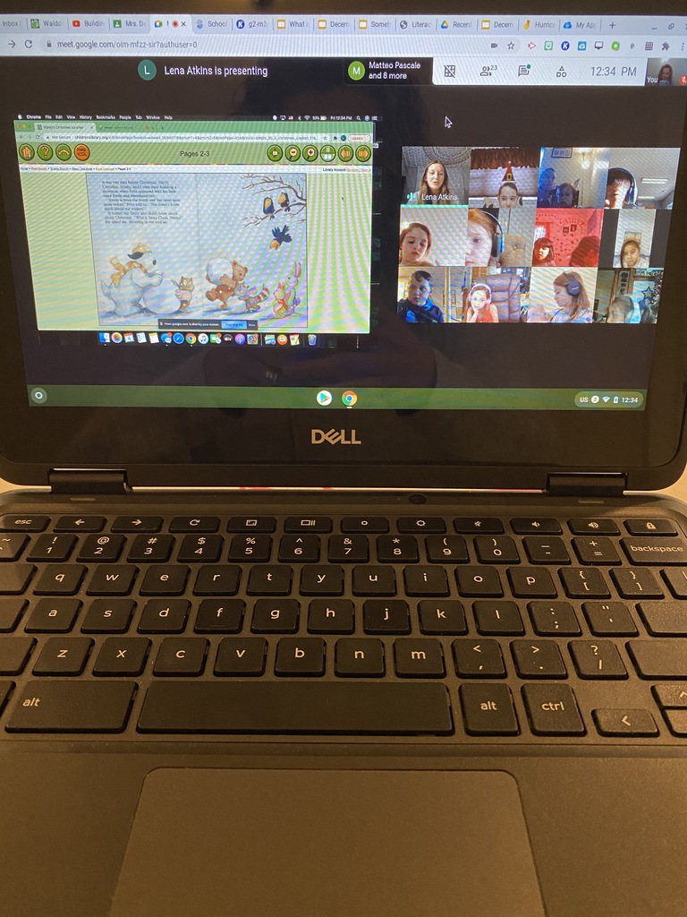 Chromebook showing book on one side of screen and Lena Atkins reading to a group of students on the right side